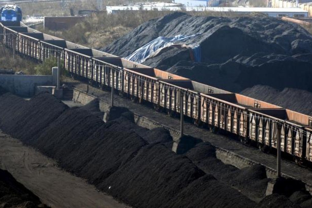 A coal train is loaded in Qingdao, Shandong. The Shanxi coal railway is China's first dedicated heavy freight line and the longest such line in the world. Photo: EPA