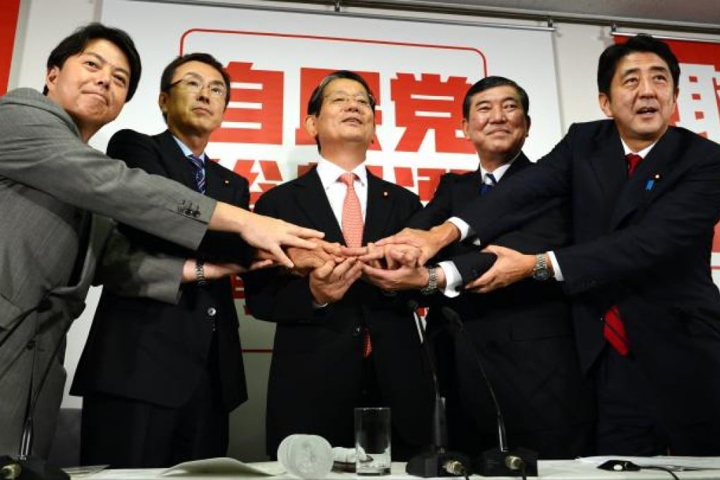 Japan's Opposition Liberal Democratic Party ( LDP) presidential election candidates, (L-R) Yoshimasa Hayashi, Nobuteru Ishihara, Nobutaka Machimura, Shigeru Ishiba and Shinzo Abe hold hand hands a a press conference in Tokyo on September 14, 2012.  Photo: AFP