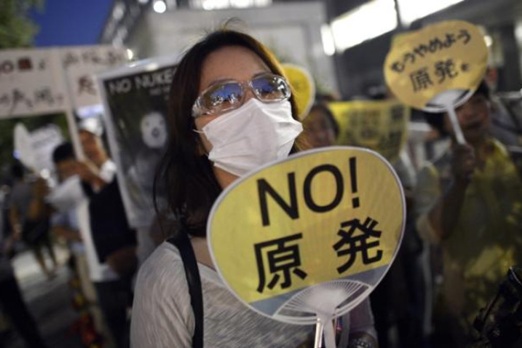 A protester holds a placard during an anti-nuclear power rally in front of the Japanese Prime Minister's official residence in Tokyo, Japan, on September 7. Photo: EPA
