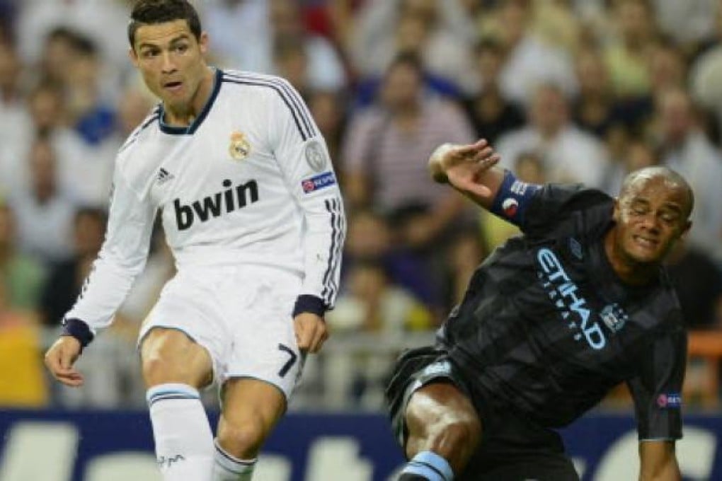 Real Madrid's Portuguese forward Cristiano Ronaldo (left) vies with Manchester City's Belgian defender Vincent Kompany (right) during the UEFA Champions League Group D football match Real Madrid vs Mancherter City in Madrid on Tuesday.