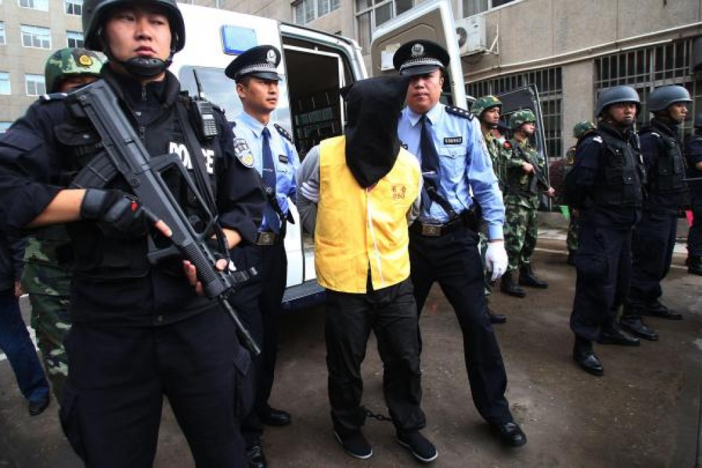 One of the six foreigners is escorted to the Kunming Intermediate People's Court yesterday. Photo: Xinhua