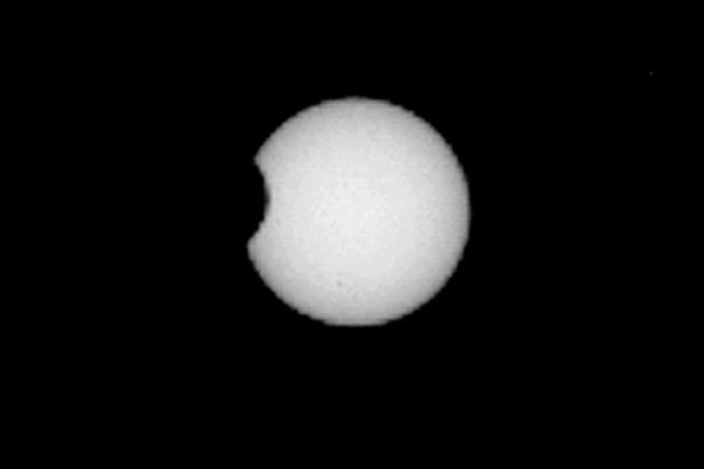 Mars' moon Phobos passes in front of the sun, in a snapshot taken by the Curiosity rover. Photo: Nasa