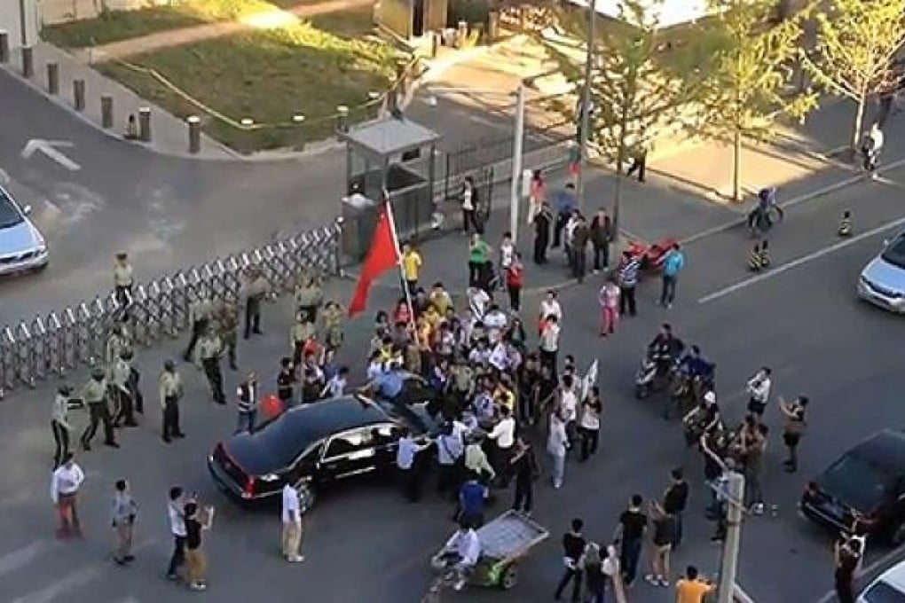 A screenshot from a video taken by Ai Weiwei of protesters surrounding US Ambassador Gary Locke's car in Beijing. Photo: AFP