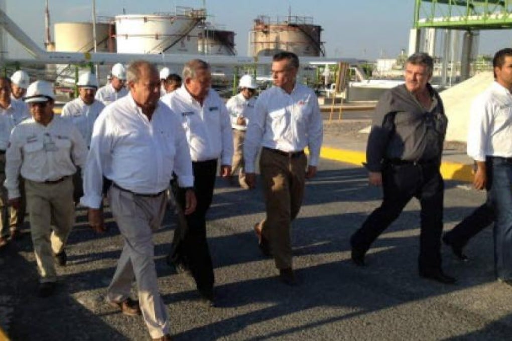 Director of Mexican state-run company Petroleos Mexicanos Juan Jose Suarez Coppel (centre) and Governor of state of Tamaulipas Egidio Torre Cantu (left) visit the refinery of the company after an explosion and a resulting fire, in Reynosa, Mexico.