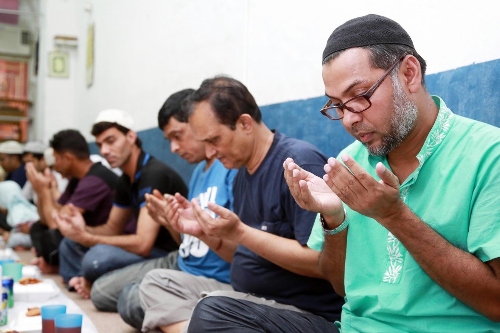 Ishaque Sarker (far right) prays at breakfast at Kowloon Mosque. Muslims fast from dawn to dusk during Ramadan.Photo: Herbert Tsang