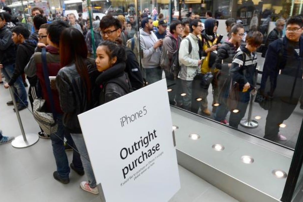 People queue to buy Apple's new iPhone 5 in Sydney as Australia becomes one of the first countries in the world to offer the phone for sale on Friday. Photo: AFP
