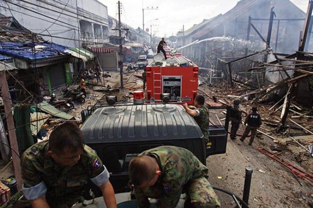 Fire crews douse the site of car bomb attack in Sai Buri town, in Thailand's restive southern province of Pattani on Friday. Photo: AFP