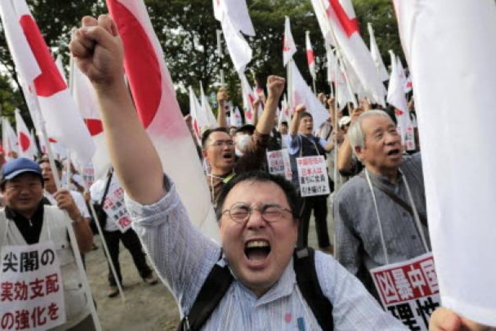 Japanese protesters shout slogans during a rally, opposing China's territorial claim over the disputed islands, called Senkaku in Japan and Diaoyu in China, at a park in Tokyo on Saturday. Photo: AP