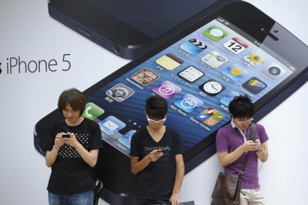 Apple fans in Tokyo line up for what has become an annual rite of passage. Japan was one of nine markets where the iPhone 5 flew off the shelves yesterday. Photo: Bloomberg
