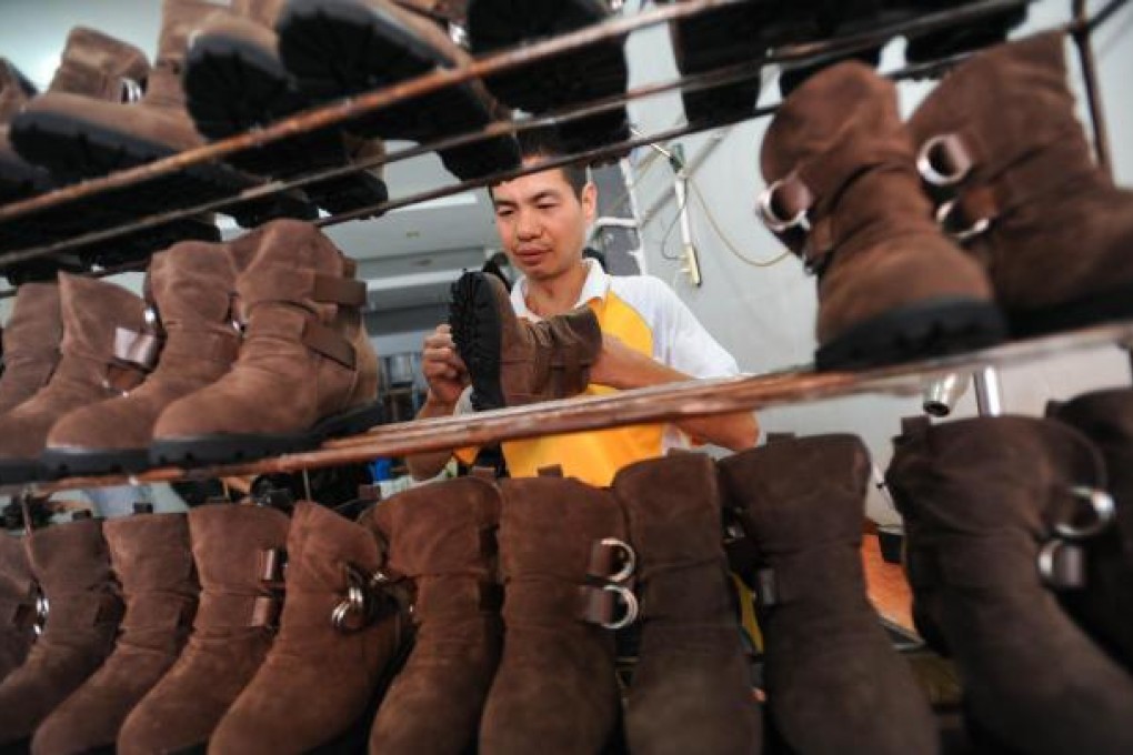 An owner works in his shoe factory in Zhejiang province to save on labour costs. Photo: Xinhua