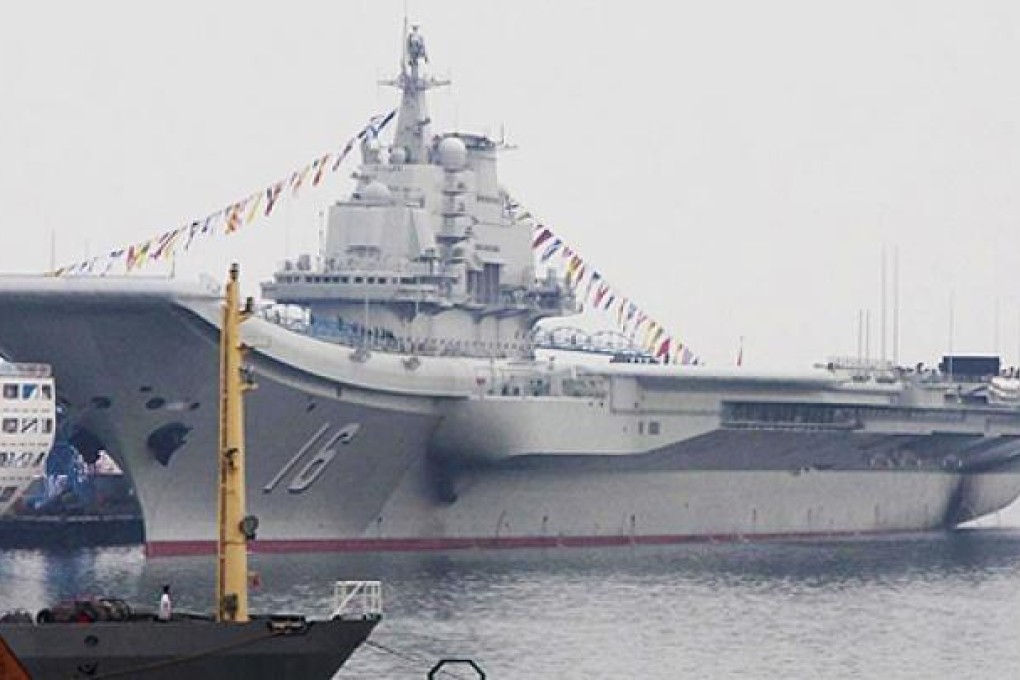 The 300-metre ship, a former Soviet carrier called the Varyag, is handed over to the navy. Photo: SCMP Pictures