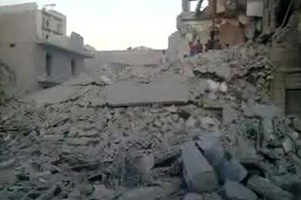 An image grab taken from a video uploaded on YouTube on Monday allegedly shows a destroyed building in which three children from one family died following a strike by Syrian regime warplanes in Maadi district, Aleppo. Photo: AFP/YouTube