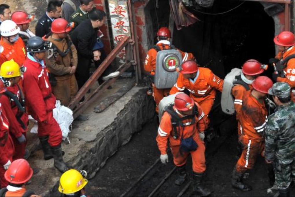 Rescuers leave the mine in Baiyin where two rail carriages carrying 34 miners ran out of control after a cable snapped. Photo: Xinhua