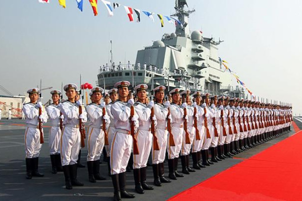 A guard of honour on the deck of aircraft carrier 'Liaoning' in Dalian. Photo: Xinhua