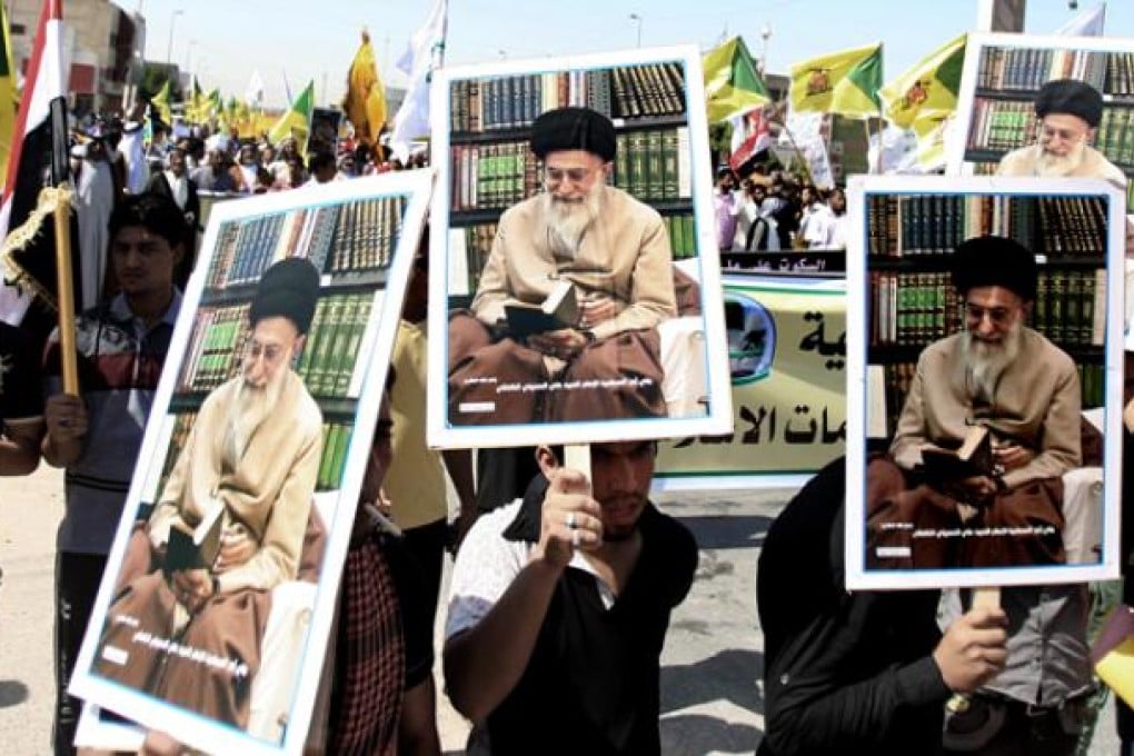 Iraqis chant slogans as they hold posters of Iran's supreme leader Ayatollah Khamenei during a protest in Basra on Friday. Photo: AP