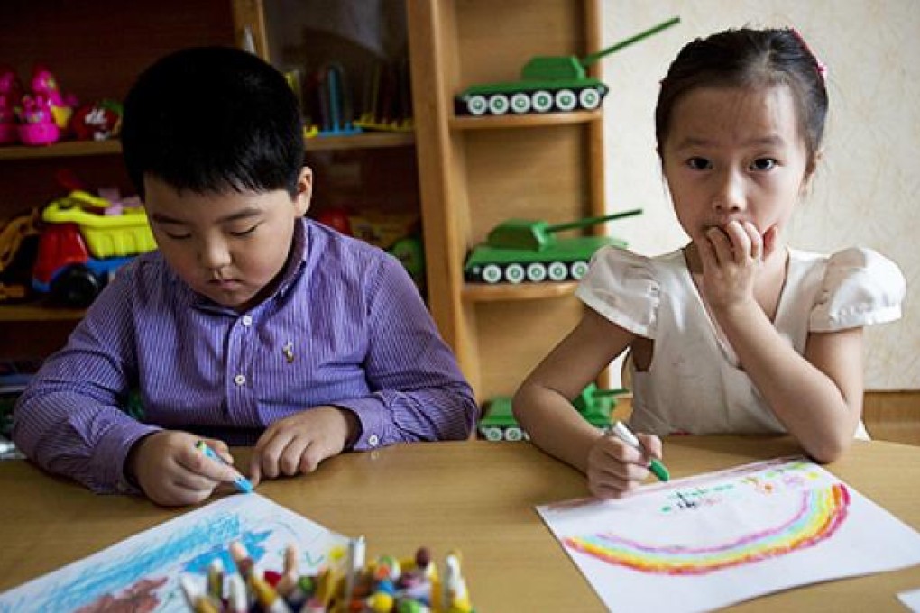 North Korean children draw pictures at a school in Pyongyang in September. State-sponsored schooling will be raised to 12 years, from 11. Photo: AP
