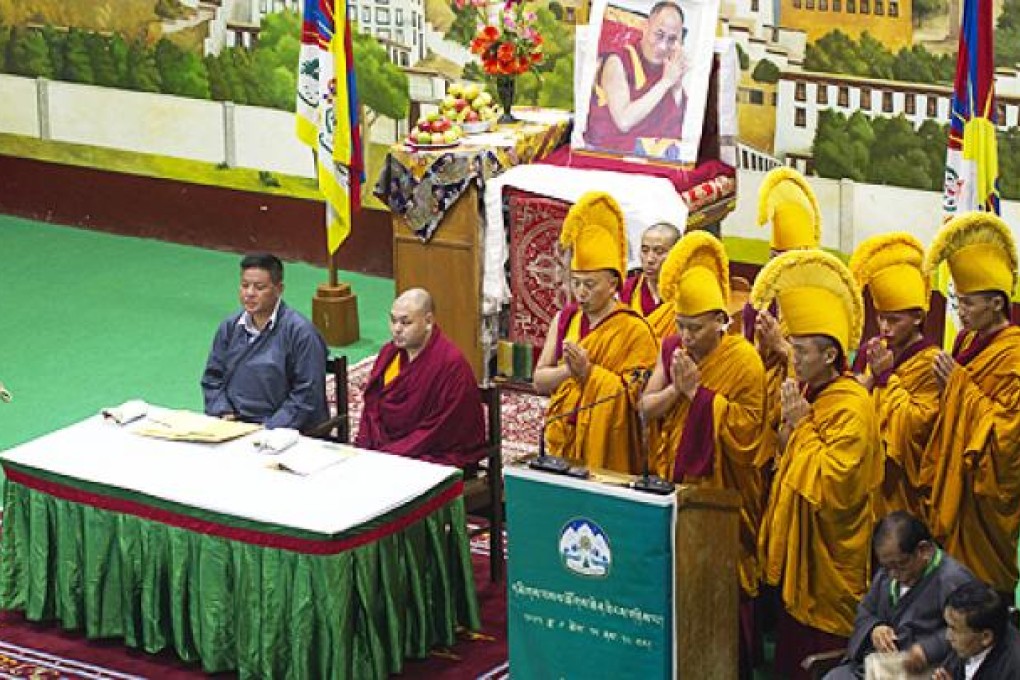 Exiled Tibetan Buddhist monks, in yellow ceremonial hats, pray during the opening ceremony of a special meeting in Dharamshala, India, on Tuesday. Photo: AP