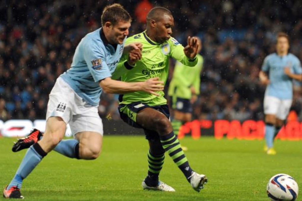 City's James Milner tackles Aston Villa's Charles N'Zogbia during their League Cup third round match in Manchester. Photo: AP