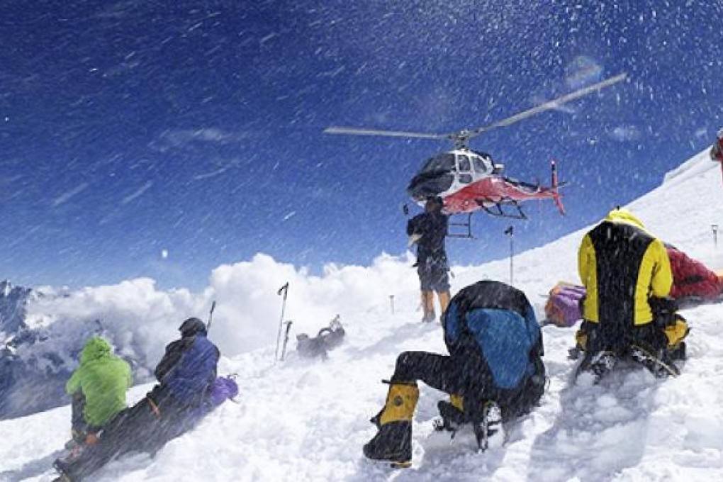 A helicopter lifts avalanche survivors to safety on Mount Manaslu on Sunday. Photo: AP