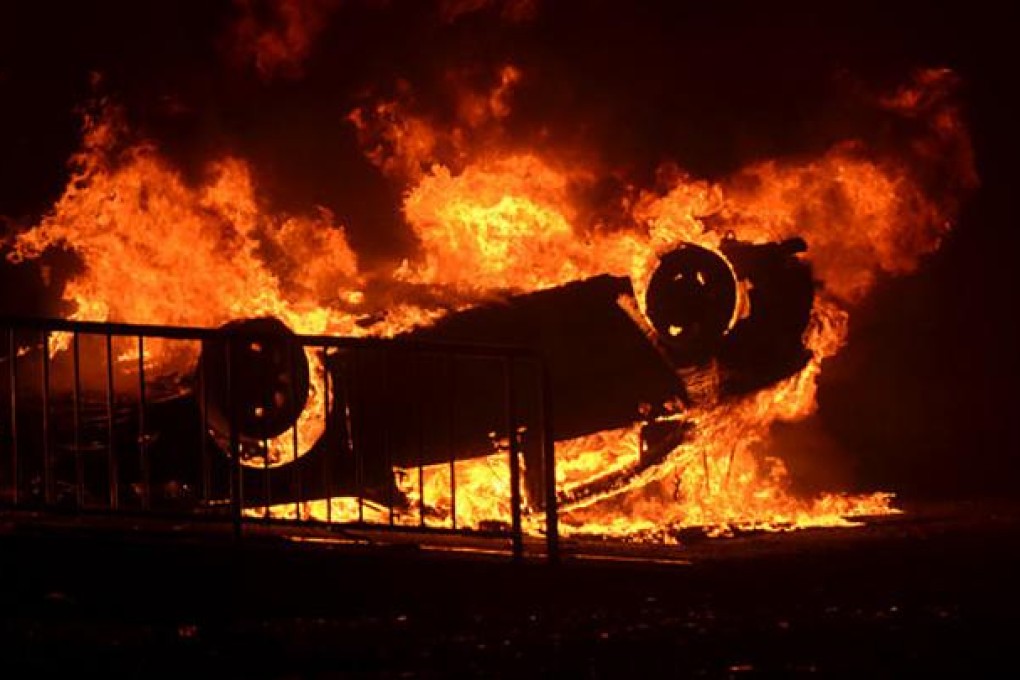 The burning wreckage of a Japanese car at an auto dealership in Qingdao, China, during recent anti-Japan protests. Photo: SCMP