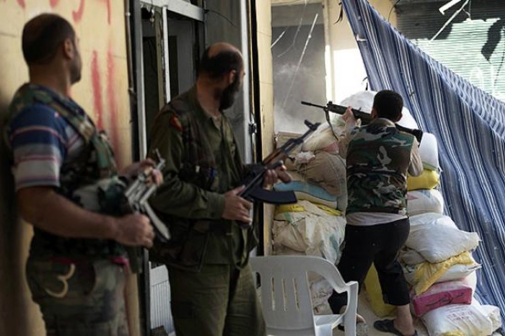 Syrian rebel fighters take their position in Salaheddine neighbourhood of Aleppo on Wednesday. Photo: AFP