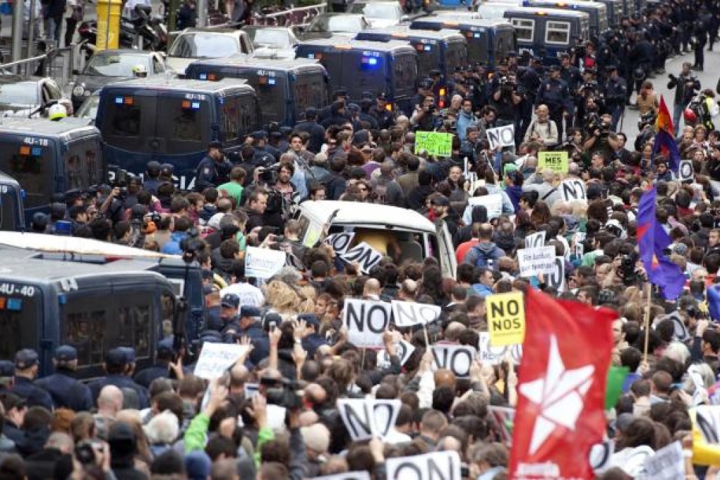 Demonstrators take part in a protest against the government's austerity measures, in front of the Parliament in Madrid.