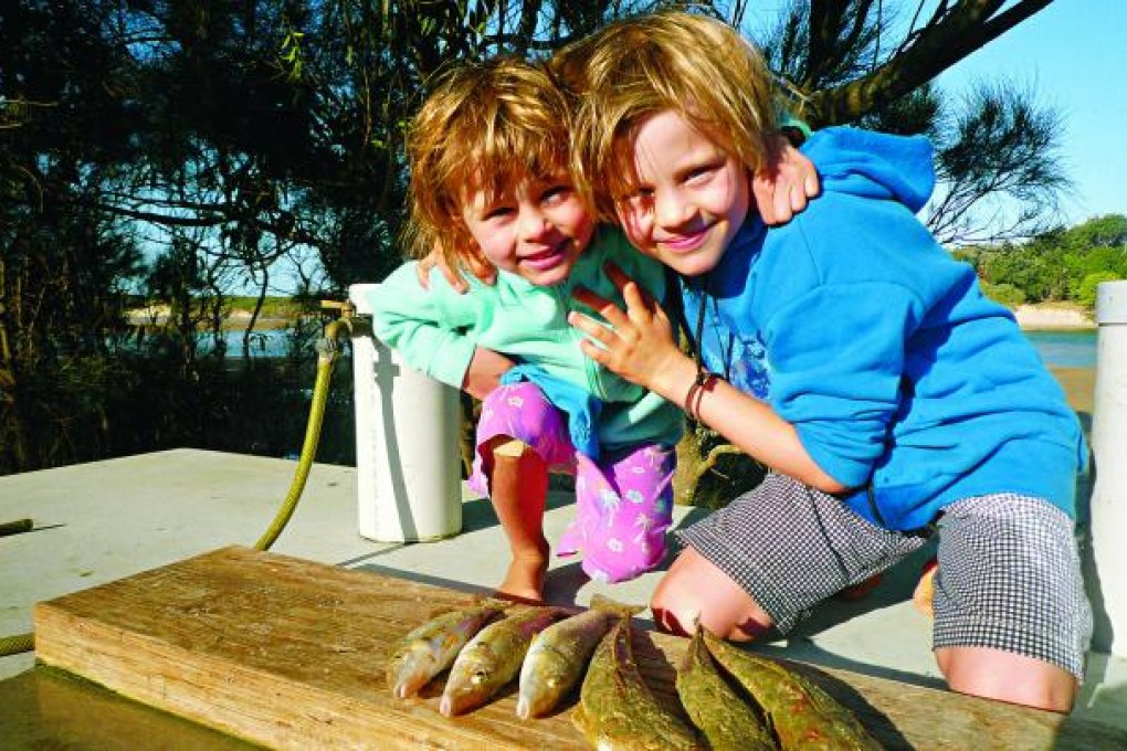 Tilly (left) and Sam in Australia with the fish the seagull didn't plunder.