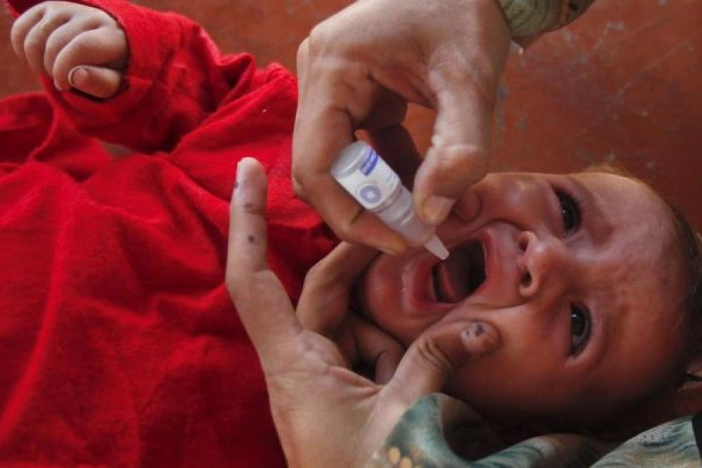 A child receives a drop of polio vaccine at the UNHCR supported Jalozai camp on the outskirts of Peshawar. Photo: Reuters