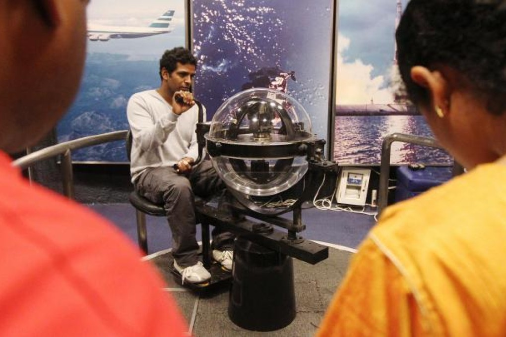 A visitor tries out a gyroscope at the museum. Photo: K. Y. Cheng