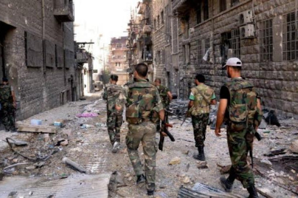 Syrian army soldiers patrolling in the street in Al-Arqoub area in Aleppo. Fighting raged in Aleppo on Saturday. Photo: EPA