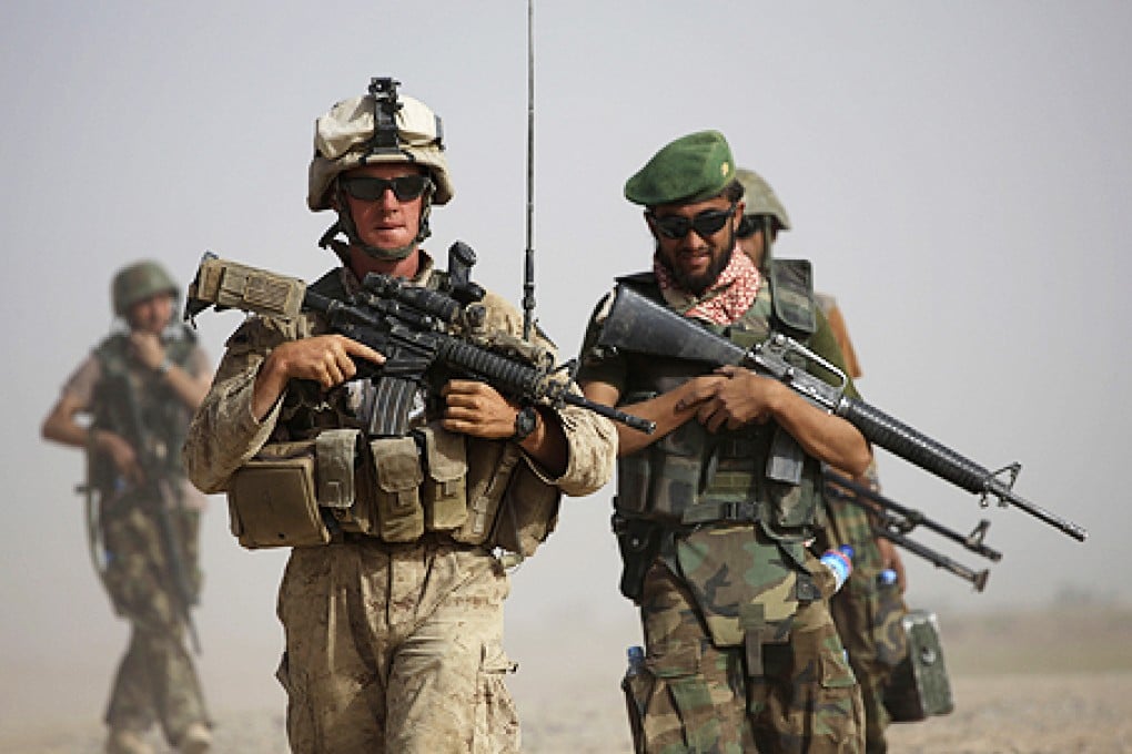 US and Afghan troops in Helmund province. A Nato soldier and a civilian contractor were killed in a suspected insider attack in eastern Afghanistan. Photo: AP