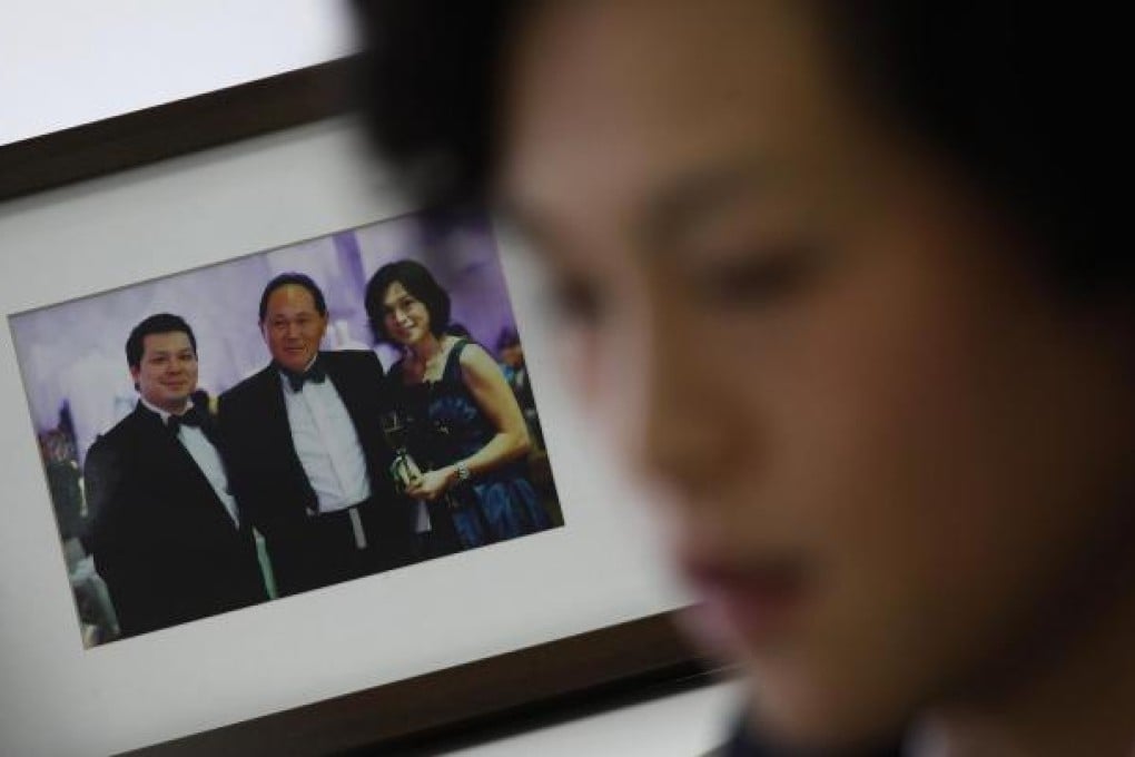 Gigi Chao, daughter of Hong Kong property tycoon Cecil Chao Sze-tsung, speaks next to a family photo of herself, her father (centre) and brother Howard. Photo: Reuters