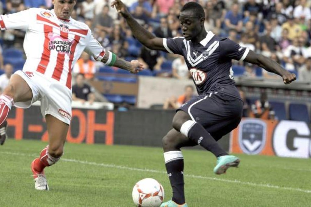 Bordeaux's French midfielder Henri Saivet (right) fights for the ball with Ajaccio's Algerian defender Carl Medjani during the French L1 football match. Photo: AFP