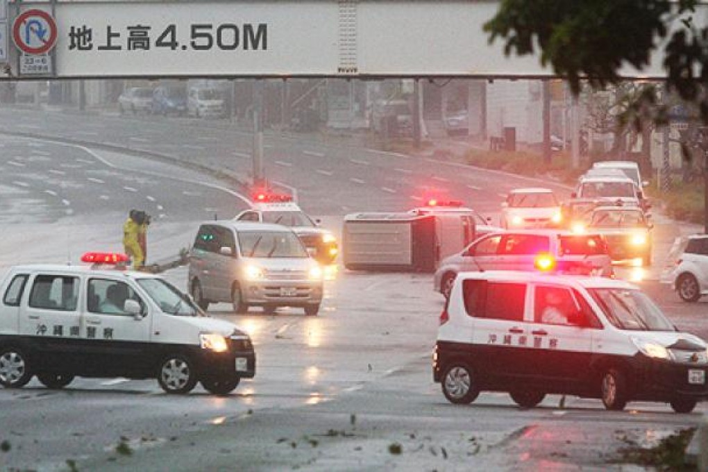 A vehicle is turned over on a road in Naha, Okinawa prefecture, as Typhoon Jelawat passed through on Saturday. Photo: AFP
