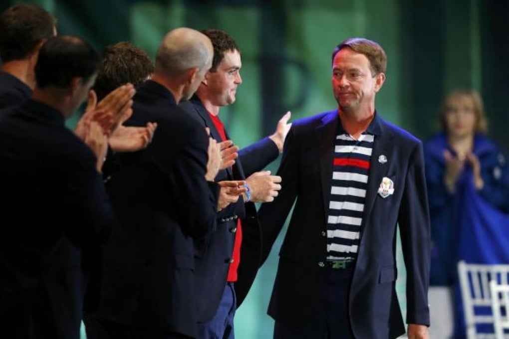 A disconsolate Davis Love is applauded by his team at the end of the day. Photo: Reuters