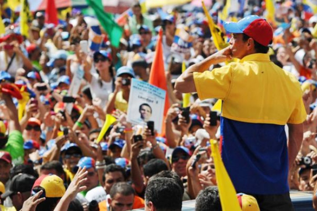 Venezuelan presidential candidate Henrique Capriles Radonsky blows a kiss to the crowd attending his campaign meeting in Caracas on Sunday. Photo: EPA