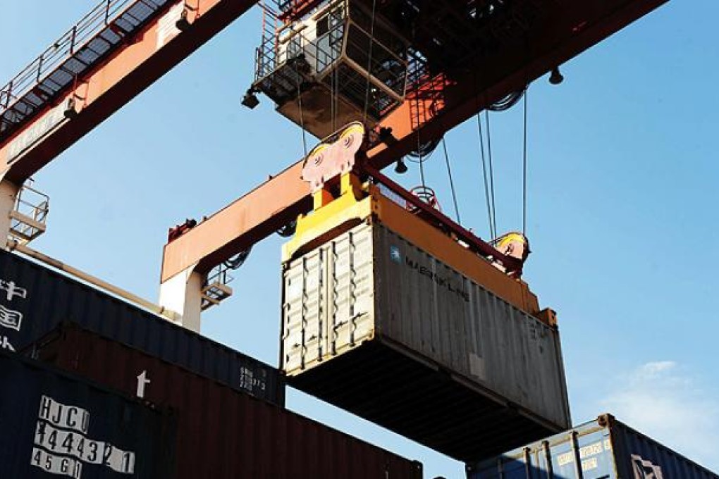 Containers are unloaded at Qingdao port, Shandong province. Photo: AFP