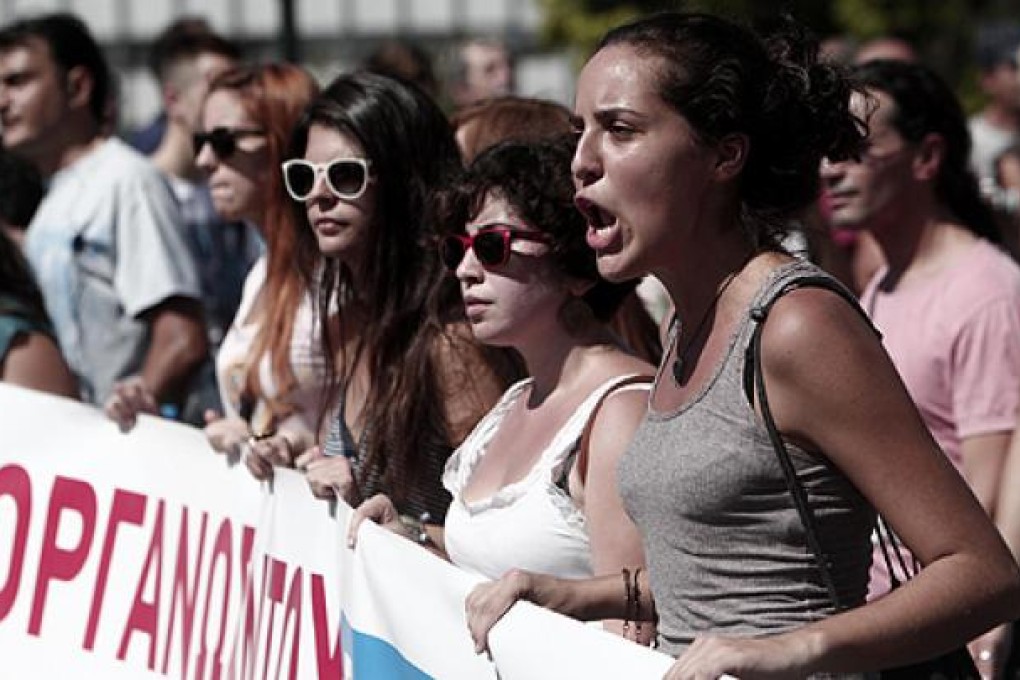 Protesters last week march in front of the Greek Parliament against austerity measures. Photo: AP