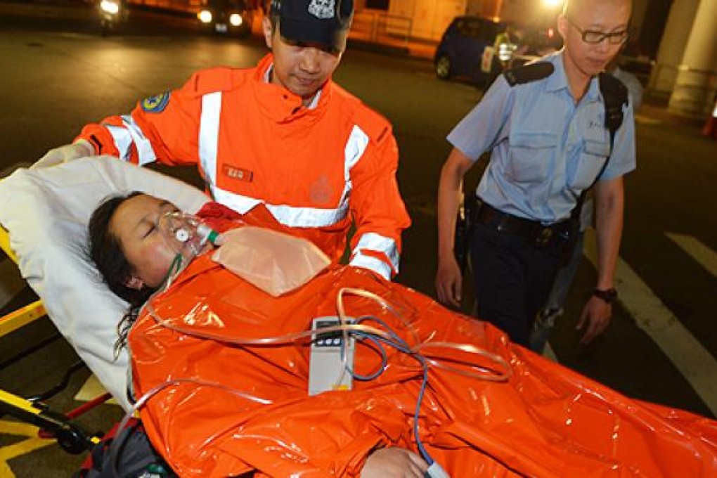 An injured passenger arrives at Queen Mary Hospital on Monday night. Photo: Thomas Yau