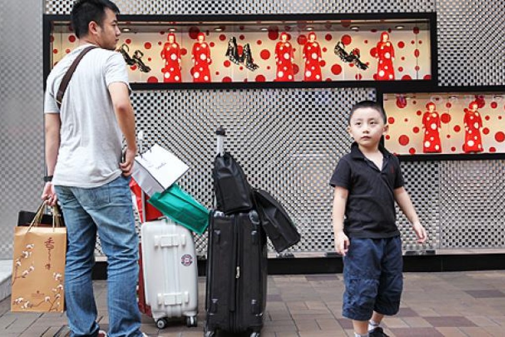 Mainland shoppers appeared upbeat, amid reports that visitors numbers are down this year. Photo: Dickson Lee