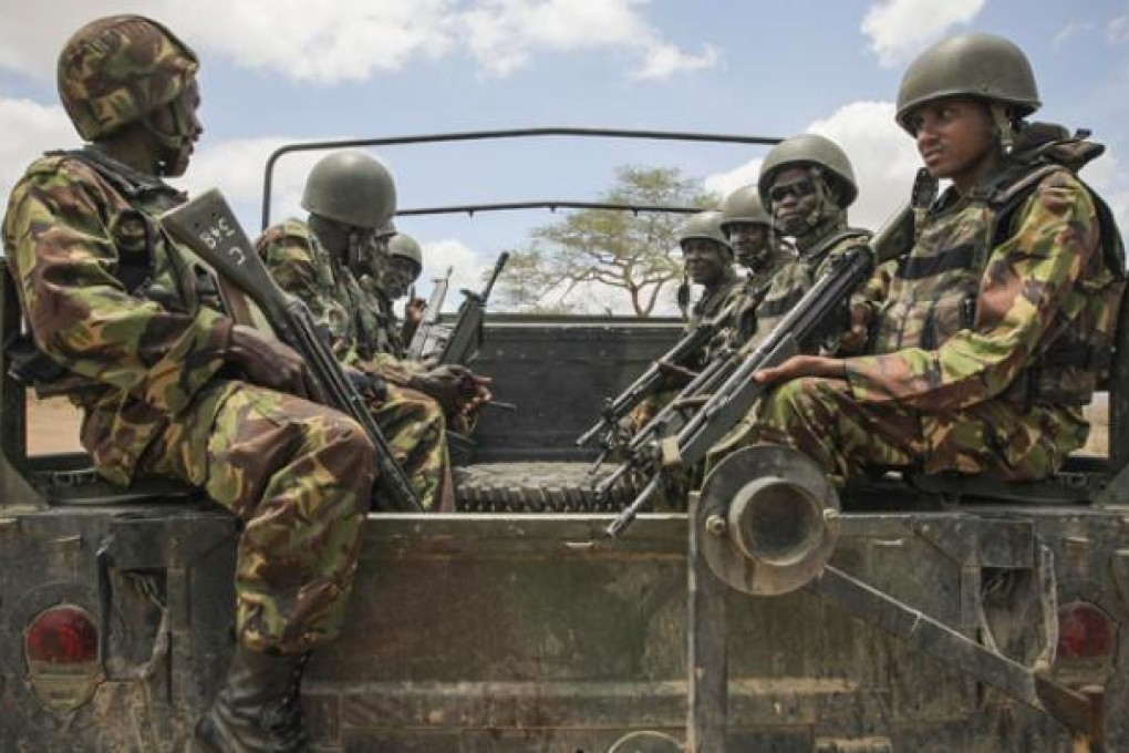 Kenyan soldiers serving with the African Union Mission in Somalia (Amisom) sit on the back of a military vehicle in southern Somalia on Sunday. Photo: AP