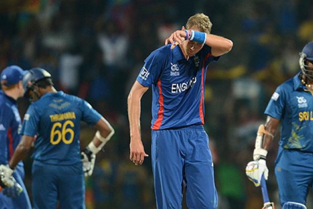 England's captain Stuart Broad (centre) wipes his face as his opponents from Sri Lanka go back to their creases. Photo: AFP
