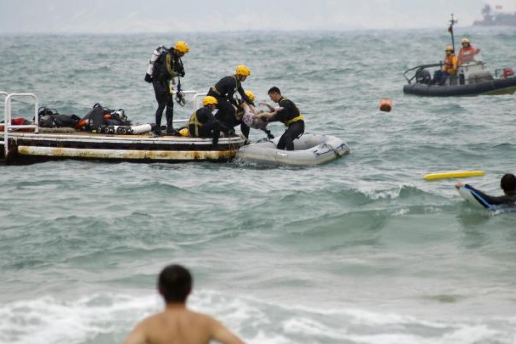 Rescuers retrieve the body of 15-year-old Choi Lai-heng who drowned off Shek O beach yesterday. Photo: SCMP