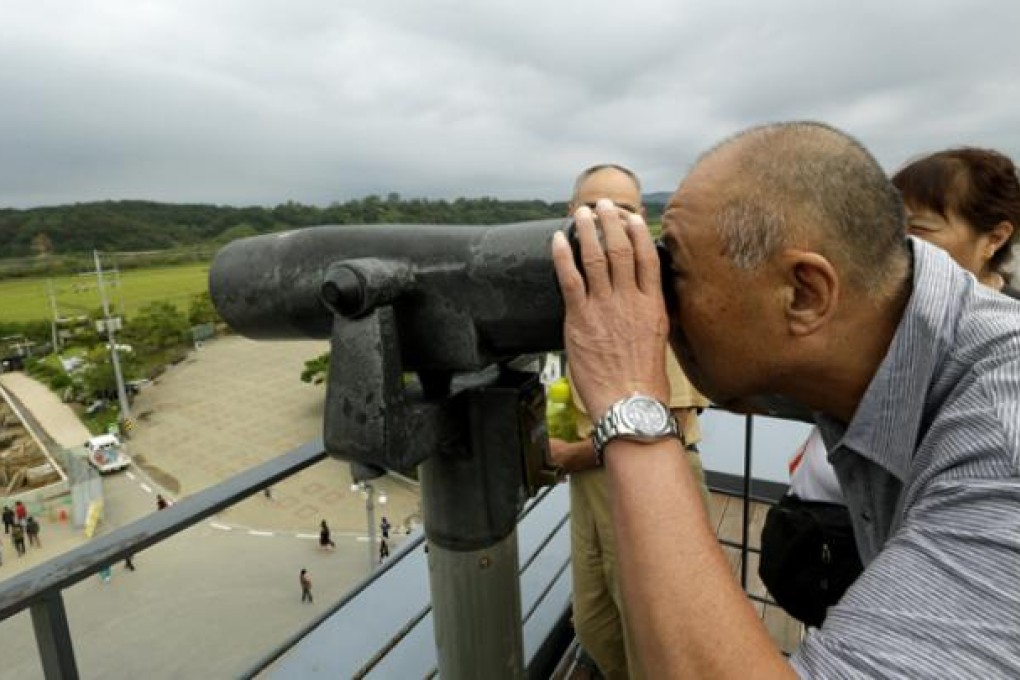 A man looks through binoculars at the Imjingak Pavilion, near the border village of Panmunjom in Paju, north of Seoul. Photo: AP