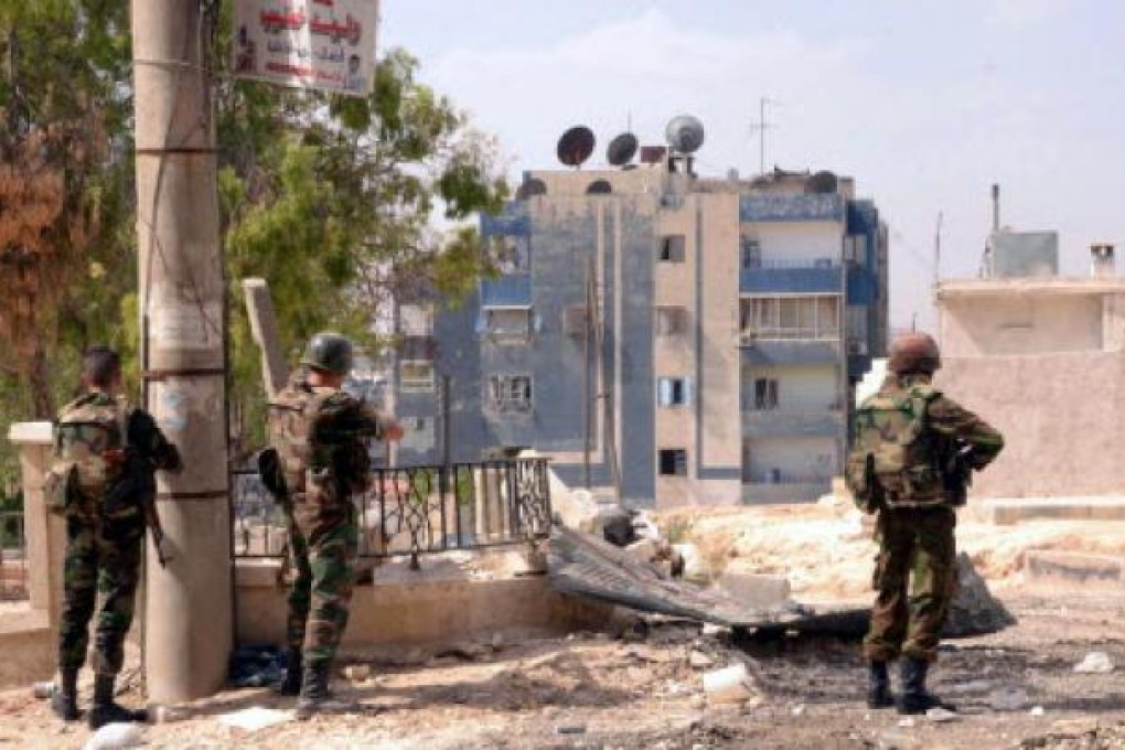 Syrian troops in action against rebel forces. Photo: EPA