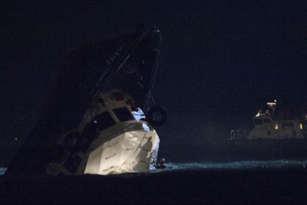 Rescuers get close to a partially-submerged vessel after a collision in Hong Kong on Oct. 1, 2012. Photo: Xinhua