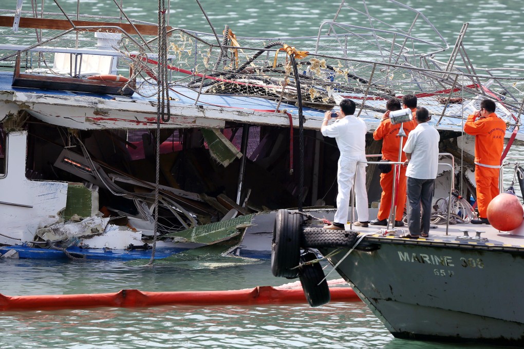 Fireman and police inspect the Lamma IV yesterday. Hongkong Electric and the vessel failed to keep a passenger list and did not ensure children wore life vests. Photo: David Wong