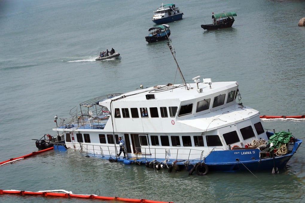 Fireman and police inspect the wreckage of the Lamma IV at Nga Kau Wan. Photo: David Wong