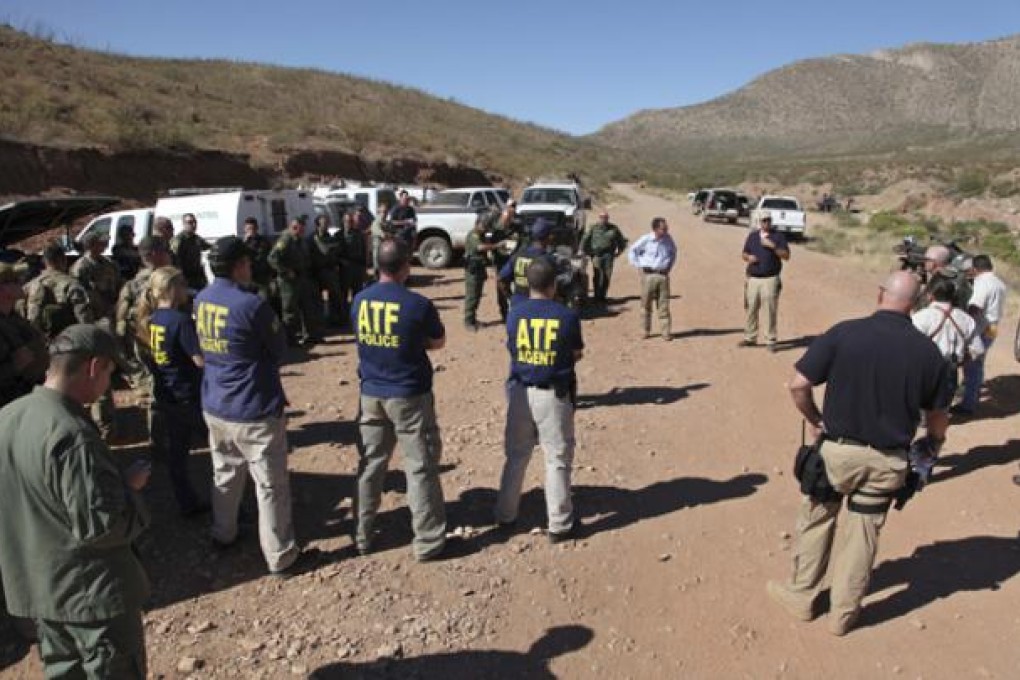 Law enforcement officers gather at a command post in the desert near Naco, Arizona, on Tuesday. Photo: AP