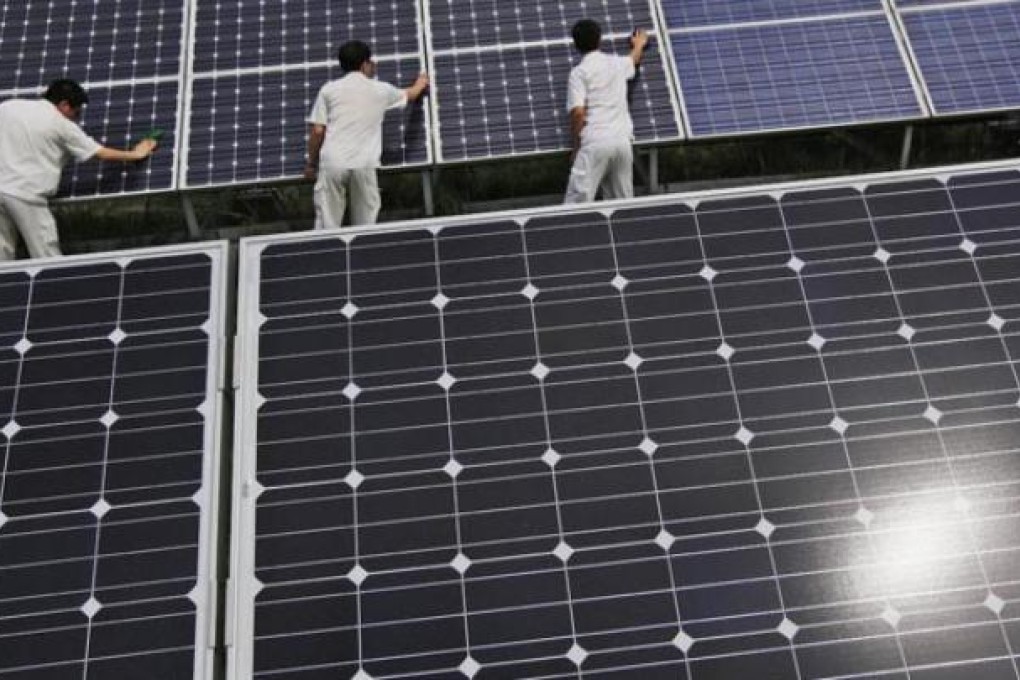 Workers clean solar panels on display at the Yingli Green Energy Holdings Company in Baoding, Hebei province. Photo: EPA